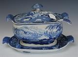 Staffordshire Blue and White Covered Tureen
With ladle and underplate, stylized mushroom finial and scrolled handles. Tureen: 8 3/4" high, 13" wide across handles, 9" wide Underplate: 15 1/2" across handles x 11".  Bid at www.fairfieldauction.com today through Wed. July 20th