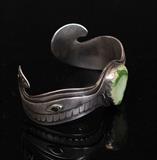 Northwest Coast Silver Bracelet
Stylized figural form with inset green hardstone and black eyes; unmarked 6 7/8" around; 49.0 dwt gross.  Bid at www.fairfieldauction.com today through Wed. July 20th