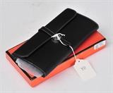 Hermes Black Leather Wallet
with checkbook holder, in original box. 3 3/4" x 8 1/4".  Bid at www.fairfieldauction.com today through Wed. July 20th