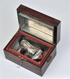 Benson & Hedges Rosewood Humidor
with brass mounts Inside of lid bearing label,  lid plaque engraved FC 1912, with key. 7 1/2" high, 13 1/2" wide, 9 1/4" wide.  Bid at www.fairfieldauction.com today through Wed. July 20th