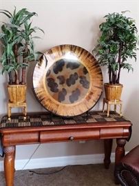 Very large decorative ceramic plate on metal stand. Silk trees in bamboo containers
