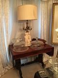 Bisque cherub lamp, with candelabra accents, candlewick glass, and an antique library table with drop leaves.