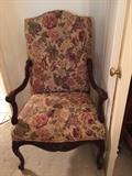 Carved arm chair with floral upholstery