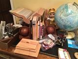 On the desk, books, old globe, airplane patches, vintage office equipment, globe book ends