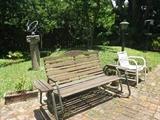 Sundial will NOT be sold - per owner. Wood rocking bench, and one of 3 vinyl strap chairs available