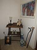 antique table with shelf and removable butler's table; Rembrandt book, blue vase, canes, handpainted book ends, torchiere lamp, clown on wood rocker