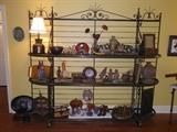 Iron and brass shelf unit with items from around the world