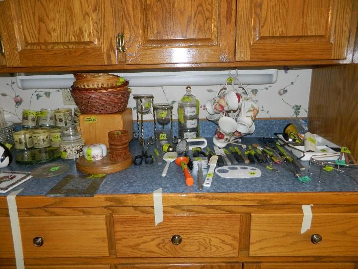 More candles, baskets, kitchen utensils, knives, various other items