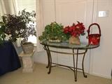 Entryway metal table with heavy glass top, pedestal, flower arrangements