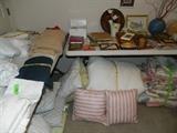 Various items on table that are collectibles; additional linens