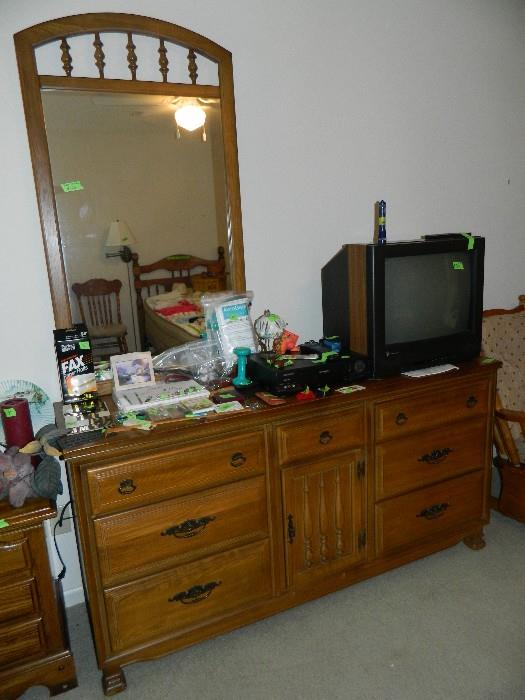 Dresser with mirror, miscellaneous items on top, dvd player and TV