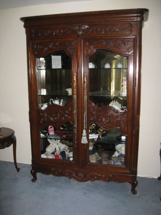 7 foot tall glass front cabinet....approximately 5-5 1/2' wide and 18-20" deep.