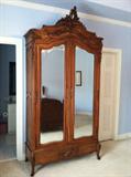 Walnut Louis XV Armoire - Large Louis XVI style solid walnut armoire. Double mirrored door. Armoire stands 102” tall, 49” wide and 20” deep with shelves that have a 15 ½” depth. Price $900