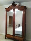 Walnut Louis XV Armoire - Our largest solid walnut armoire. Double mirrored door. Armoire stands 104” tall, 58” wide and 21” deep with shelves that have a 16” depth. Price $900