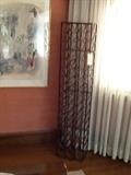 Wine rack with wrought iron and leather straps a Chagall lithograph next to
