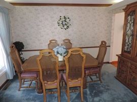 Pecan wood set includes table w/ two 20" leaves & pads, six cane back chairs and china cabinet 