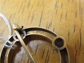 Clasp and pin marked 14k, glass gemstones are imperfect