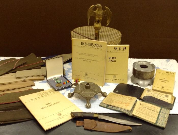 1943 South St Louis Ration Books with covers, Air Force souvenir ashtray NELLIS AIR FORCE BASE,
Grand Army of the Republic Flag Pole Stand,
Misc Metals, Flag pole Eagle, 1945 Philippines Souvenir Knife with leather sheath, Assortment of Military Handbooks
