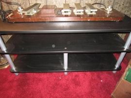 TV stand with part of an early pedal steel guitar sitting on it