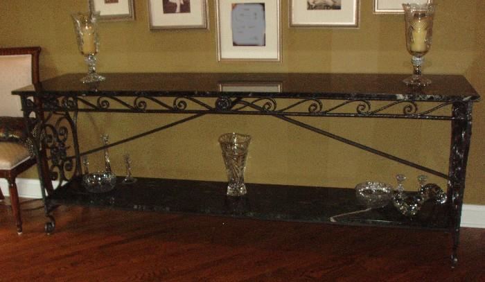 One of two 8' long white vein marble top and bottom shelf tables.   This marble on these tables is over 100 years old.  Stunning pieces.  Some crystal decor as well