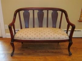 Setee:  Dark cherry frame, front claw feet, on wheels, innerspring seat