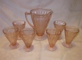 Depression glass pitcher and glasses by Jeannette Glass, "Floral Poinsettia" pattern.