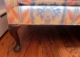 Two vintage camel back love seats, with curved Mahogany legs. Solid construction.
