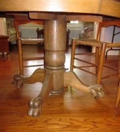 Antique 42" round table.  Solid oak pedestal base with carved feet, on wheels, pine top - minor condition issues.