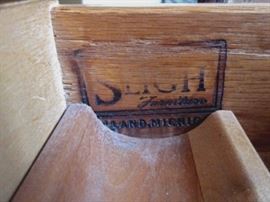 High-quality desk by Sligh.  Three tooled leather inlays, 5 drawers, brass drawer pulls.  One spot of damage to leather.
