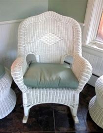 Vintage white wicker rocking chair.