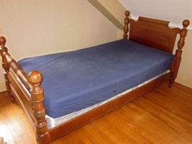 Solid wood (dark maple) twin bed with head board, foot board, side rails, mattress and box spring.