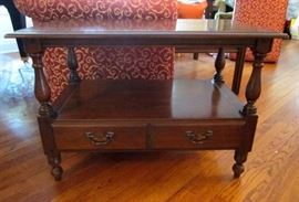 Two solid Cherry wood end or side tables, with shelf, two bottom drawers and brass pulls by Harden.  Tops have some staining from plants.  32" wide, 19" deep, 22" tall.