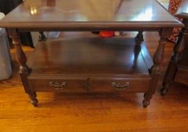 Two solid Cherry wood end or side tables, with shelf, two bottom drawers and brass pulls by Harden.  Tops have some staining from plants.  32" wide, 19" deep, 22" tall.