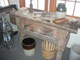 Great farm bench with crocks and old tools