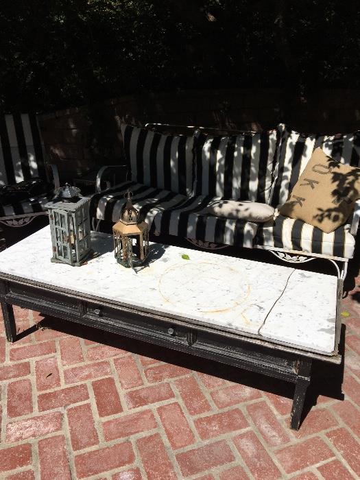 Marble top patio coffee table and wrought iron couch