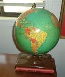cool vintage globe on stand with reference book