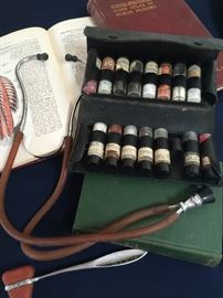 Antique doctors pill case, stethoscope , old medical books