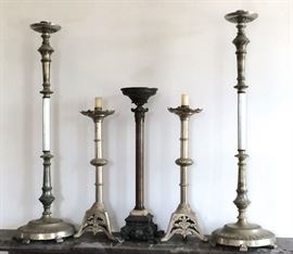 `A grouping of tall metal standing candlesticks, (altar candles) approximately 36" H