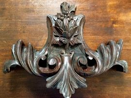 carved wood ornamental architectural detail (probably from a piece of furniture)