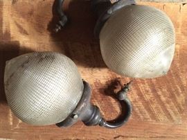 Old light fixtures with cut glass globes, located at street level in Workshop