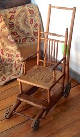 Antique baby stroller that turns into a high chair with eating tray, wood with cane seat