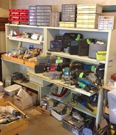 Work bench loaded with tools, painting supplies, air sprayers, extension poles ...