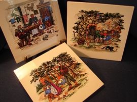 Three German ceramic trivets depicting fairy tales.