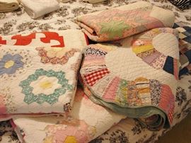 Several lovely handmade quilts passed down through the years.
