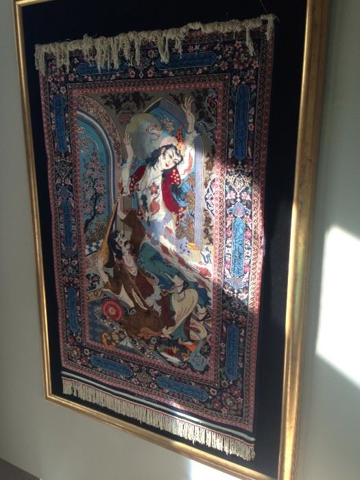 A polychromatic figurative,
indian wool tapestry. 70 inches long
and 50 inches wide including
the frame.