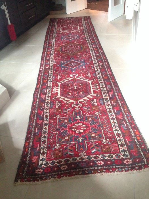 Polychromatic, geometric
patterned wool Persian rug. The piece is 35 inches
wide and 150 inches long with
roughly 196 knots per square
inch.