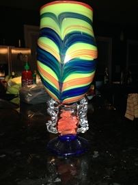 Murano-style, Venetian glass
chalice with shades of red,
orange, yellow, green and blue
on a circular base.  The piece is
11.5 inches high and 5.25
inches wide.