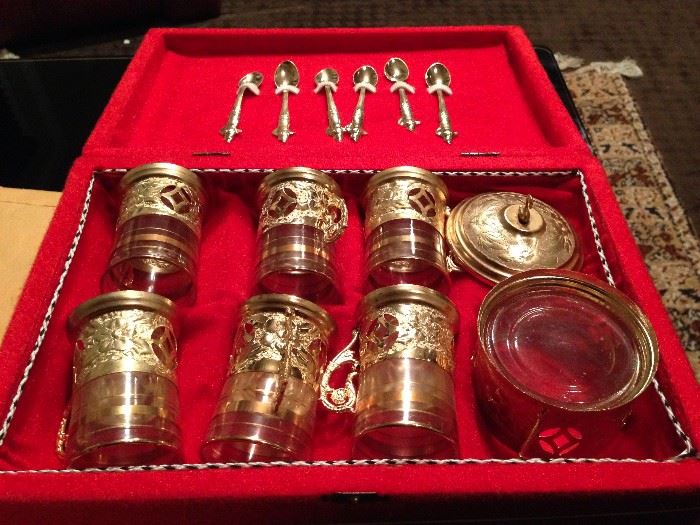 A Turkish tea set made of brass
including six glass cups with brass
holders, a sugar bowl made of glass
with a brass holder and six brass
teaspoons. The piece cups are 3.5
inches high and 2.5 inches wide. The
sugar bowl is 3.5 inches high and 3.5
inches wide. Each spoon is 4.5 inches
long. The set comes with a padded
case.