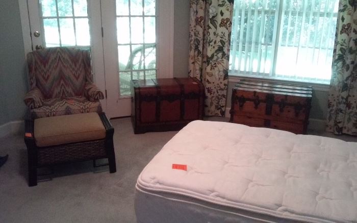 Twin bed, old & new trunks, wing back chair