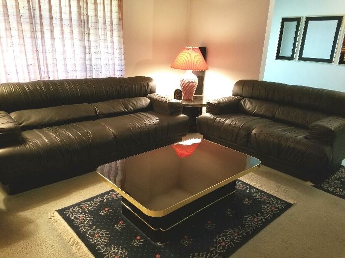 Faux leather couch and loveseat, decorative coffee table and lamps